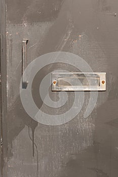 iron mail slot rusty steel door closeup photo