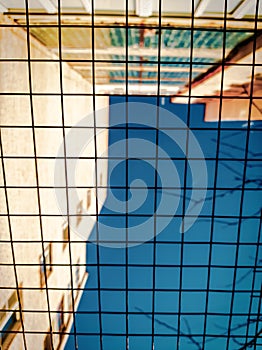 iron netting against the blue sky