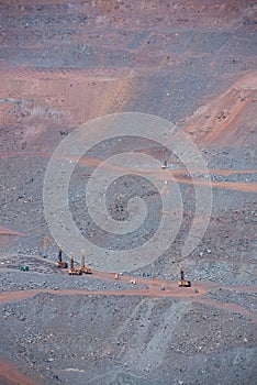 Iron ore quarry landscape with career blasting machines ready to explode