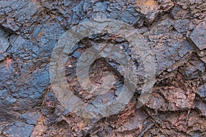 Iron ore texture close up - natural minerals in the mine. Stone texture of open pit. Extraction of minerals for heavy