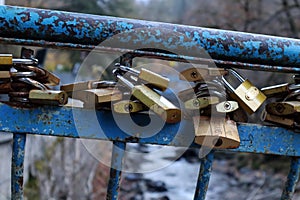 Iron padlocks on a river bridge. Borjomi central park, Georgia