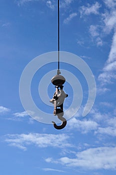 A iron pendulum hook with blue sky.
