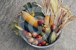 Iron plate with autumn harvest farm vegetables and root crops. Healthy and organic food background. Concept of Healthy Fresh Food