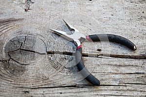 Iron pliers on a old rustic wooden table
