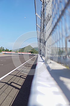 Iron rails at a racing circuit, photo focused on the asphalt of the circuit