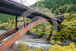 Iron railway bridge over Hozu River in Arashiyama, Japan