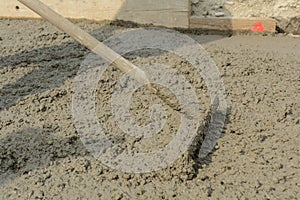 With iron rake smooth concrete surfaces