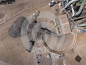 Iron raw materials recycling pile, work machines. Metal waste junkyard. View from above.