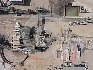 Iron raw materials recycling pile, work machines. Metal waste junkyard. View from above.