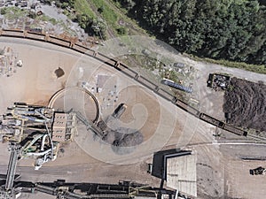 Iron raw materials recycling pile, work machines. Metal waste junkyard. View from above.