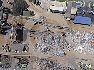 Iron raw materials recycling pile, work machines. Metal waste junkyard. View from above.