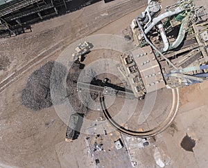 Iron raw materials recycling pile, work machines. Metal waste junkyard. View from above.