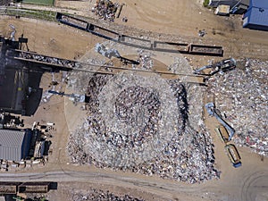 Iron raw materials recycling pile, work machines. Metal waste junkyard. View from above.
