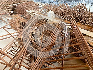 Iron rusty bars of wire reinforcement for building houses and producing industrial reinforced concrete at a construction site