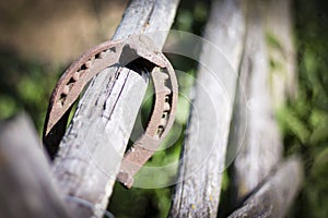 Iron rusty horseshoe with soft shadow on a dark background. The old horseshoe. A symbol of luck and happiness. St.Patrick `s Day.