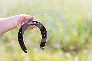 Iron rusty horseshoe with soft shadow on a dark background. The old horseshoe. A symbol of luck and happiness. St.Patrick `s Day.