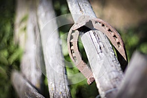 Iron rusty horseshoe with soft shadow on a dark background. The old horseshoe. A symbol of luck and happiness. St.Patrick `s Day.