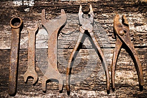 Iron rusty tools working on an old wooden