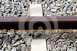 Iron rusty train railway detail over dark stones