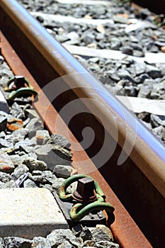 Iron rusty train railway detail over dark stones