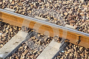 Iron rusty train railway detail over dark stones rail way