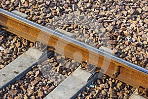 Iron rusty train railway detail over dark stones rail way