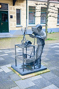 Iron statue of a blacksmith holding two keys