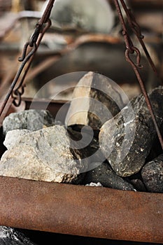 Iron stove with stones and soot macro