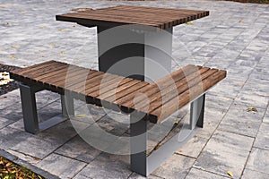 iron table and bench with a surface of wooden planks in the yard photo