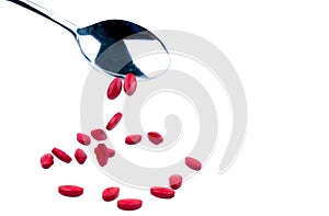 Iron tablets in spoon isolated on white background with copy space for text and clipping path. Use for topics about treatment anem