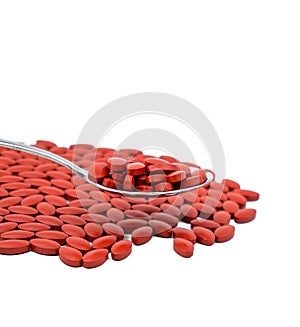 Iron tablets in spoon isolated on white background with copy space for text. Use for topics about treatment anemia photo