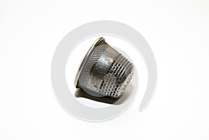 Iron thimble for hand embroidery on a white background