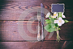 Iron vintage cutlery with a bouquet of jasmine