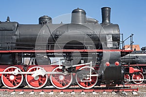 Iron wheels of mighty steam locomotives, red iron wheels of steam locomotives, steel wheels of a steam locomotive, steel power of