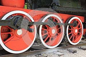 Iron wheels of an old vintage locomotive on iron rails close-up