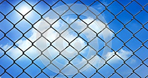 Iron wire fence on blue sky background .