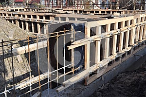 Iron and wooden framework to build a house foundation uder construction. Incomplete house foundation construction site