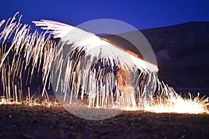 Iron wool circle drawing light fireworks. Burning Steel Wool spinning, Trajectories of burning sparks at night. Movement light eff