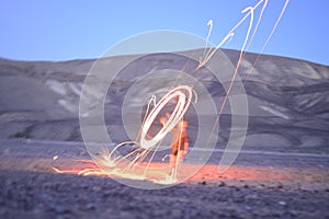 Iron wool circle drawing light fireworks. Burning Steel Wool spinning, Trajectories of burning sparks at night. Movement light eff