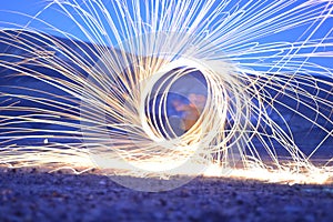 Iron wool circle drawing light fireworks. Burning Steel Wool spinning, Trajectories of burning sparks at night. Movement light eff