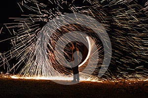 Iron wool circle drawing light fireworks. Burning Steel Wool spinning, Trajectories of burning sparks at night. Movement light eff