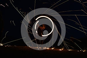 Iron wool circle drawing light fireworks. Burning Steel Wool spinning, Trajectories of burning sparks at night. Movement light eff