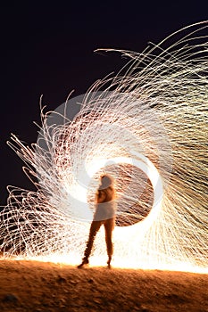 Iron wool circle drawing light fireworks. Burning Steel Wool spinning, Trajectories of burning sparks at night. Movement light eff