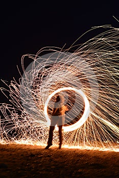 Iron wool circle drawing light fireworks. Burning Steel Wool spinning, Trajectories of burning sparks at night. Movement light eff