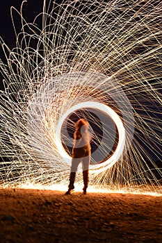 Iron wool circle drawing light fireworks. Burning Steel Wool spinning, Trajectories of burning sparks at night. Movement light eff