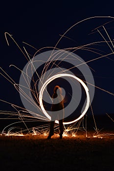 Iron wool circle drawing light fireworks. Burning Steel Wool spinning, Trajectories of burning sparks at night. Movement light eff