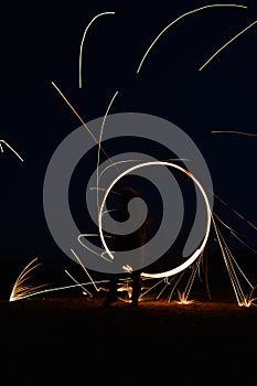 Iron wool circle drawing light fireworks. Burning Steel Wool spinning, Trajectories of burning sparks at night. Movement light eff