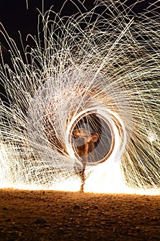 Iron wool circle drawing light fireworks. Burning Steel Wool spinning, Trajectories of burning sparks at night. Movement light eff