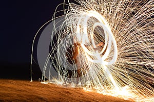 Iron wool circle drawing light fireworks. Burning Steel Wool spinning, Trajectories of burning sparks at night. Movement light eff