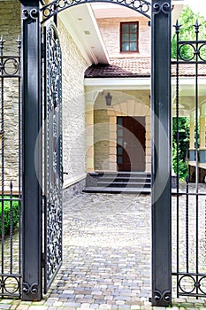 Iron wrought iron gate entrance to the back yard.